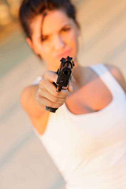 istock Young woman with a gun 480133601