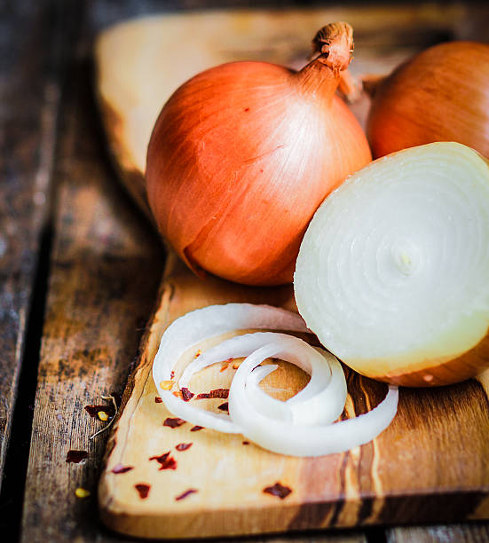 istock Golden onions on rustic wooden background 480134141