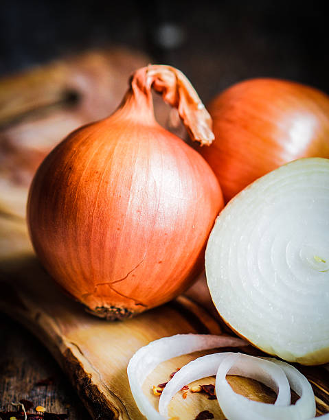 istock Golden onions on rustic wooden background 480134177
