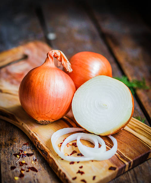 istock Golden onions on rustic wooden background 480134213