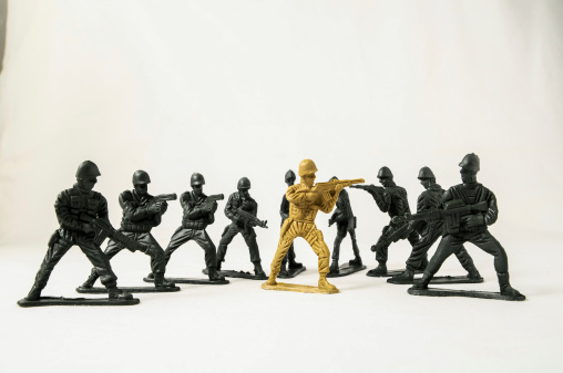 Plastic Lead Soldiers Representing War on a White Background