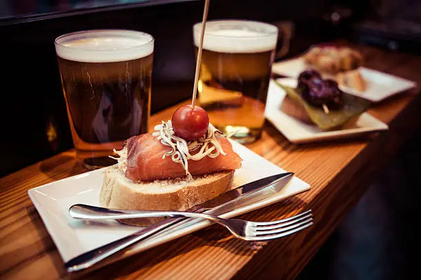 Pinchos or pintxos, traditional Basque Country appetizer. Served with beer