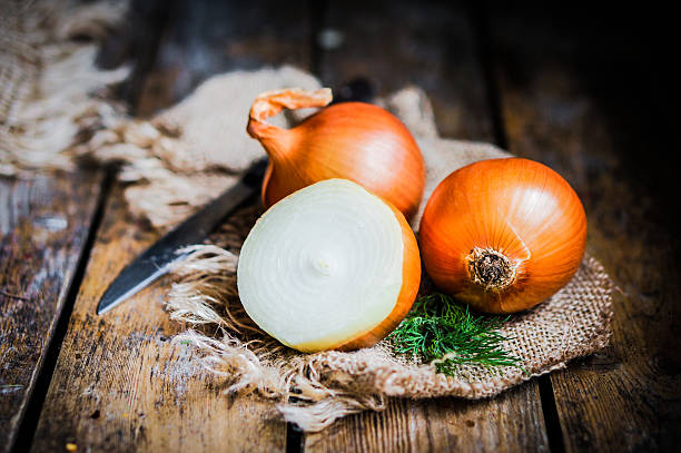 istock Golden onions on rustic wooden background 480135281