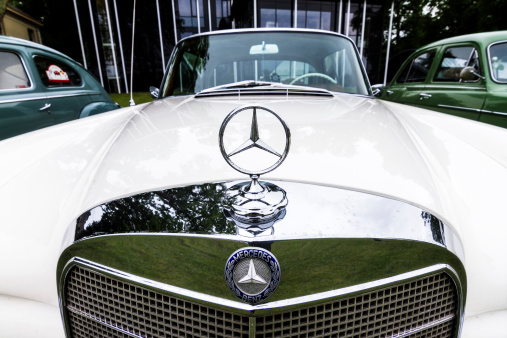 Deventer, The Netherlands - June 28, 2013: Beautiful close up of an oldtimer white Mercedes seen from the front during an oldtimer car gathering in the Netherlands on June 28, 2013