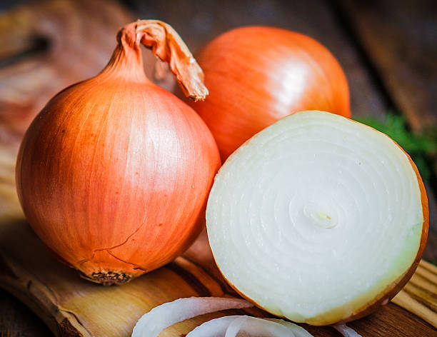 istock Golden onions on rustic wooden background 480135637