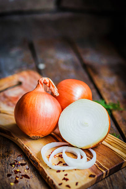 istock Golden onions on rustic wooden background 480135745