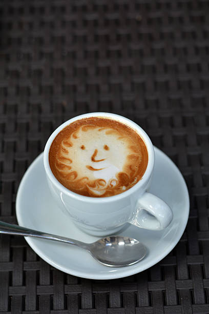 istock Cup Of Foamy Cappuccino With Smile On A Black Background 480135838