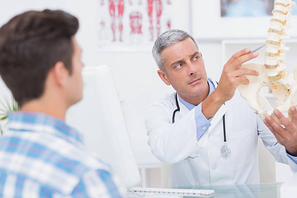 istock Doctor explaining anatomical spine to his patient 480135906