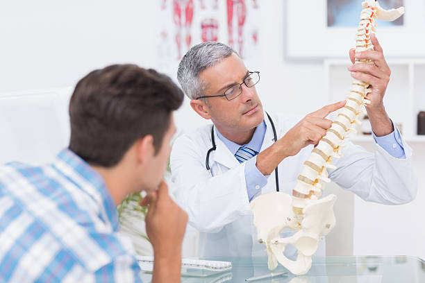 istock Doctor explaining anatomical spine to his patient 480136116