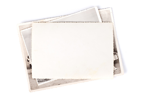 Stack of old photos isolated on white background.