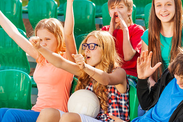 istock Teenagers cheer for team during game at stadium 480137162