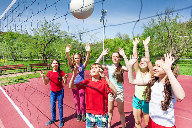 istock Group of teens playing volleyball near the net 480143218
