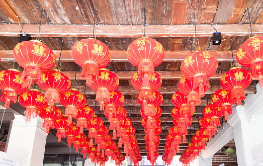 Chinese lanterns hanging from an old wooden ceiling in Old Phuket Town, Thailand