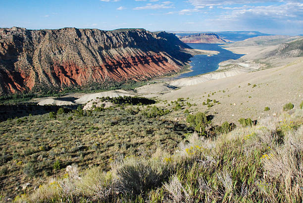 Flaming Gorge Reservoir Landscape view Utah Red rocks and sand dunes of Flaming Gorge National Recreational Area and the reservoir in the distance at overlook north of Dutch John near Utah/Wyoming state line vernal utah stock pictures, royalty-free photos & images