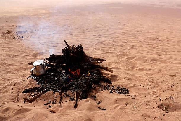 istock Boiling water in kettle on fire in desert 480145871