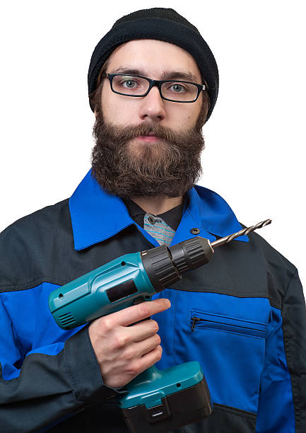istock bearded man holding in a hand the electric drill 480146705