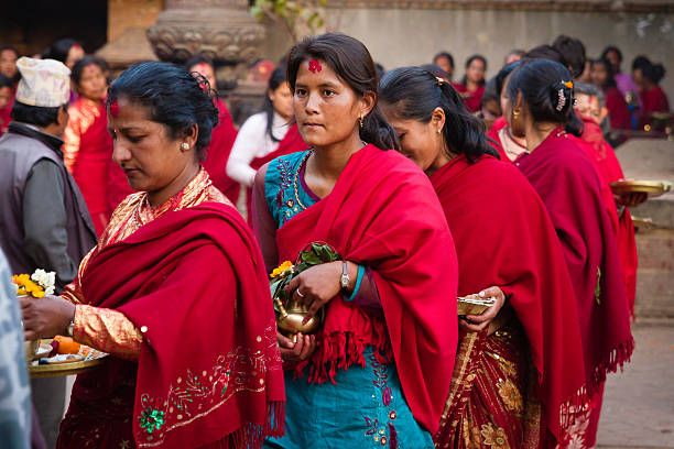 Bhaktapur, Nepal - February 25, 2013: Unidentified Hindu women parade in the street on 25 February 2013 in Bhaktapur, Nepal.