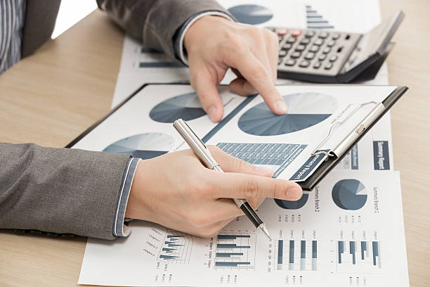 istock business report and man hand with pen 480147377