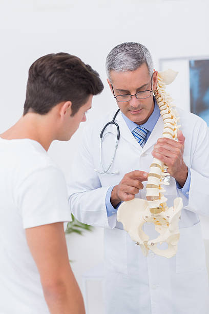 istock Doctor explaining anatomical spine to his patient 480147904