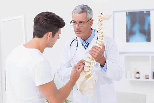 istock Doctor explaining anatomical spine to his patient 480147906