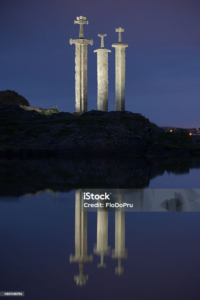 The Three Swords Monument at Night, Stavanger, Norway A night shot of the Three Swords monument. Called Sverd i Fjell in Norwegian, it is located in a popular recreation area.  Norway Stock Photo