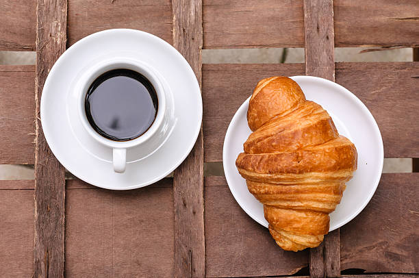 istock cup of coffee with croissant 480148382