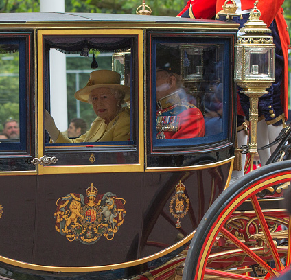 London, England - June 16, 2012: Queen Elizabeth II and the Duke of Edinburgh in a carriage on the Mall en route from Buckingham Palace for the Trooping of the Colours at the Horseguards Parade.