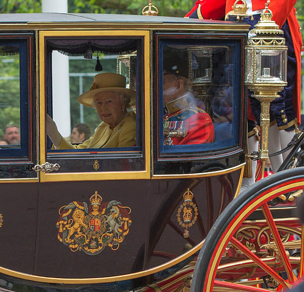 Queen Elizabeth and the Duke of Edinburgh in Carriage London, England - June 16, 2012: Queen Elizabeth II and the Duke of Edinburgh in a carriage on the Mall en route from Buckingham Palace for the Trooping of the Colours at the Horseguards Parade. duke photos stock pictures, royalty-free photos & images