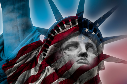 Double exposure image of the Statue of Liberty and the American flag