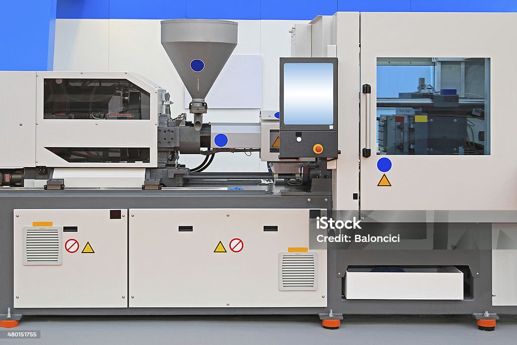 Injection molding machine Injection molding machine for thermo plastic polymers Molding a Shape Stock Photo