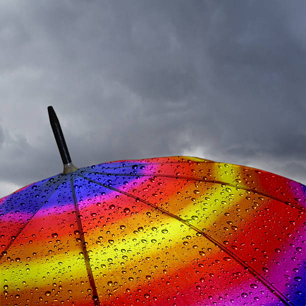 istock Colorful umbrella top with raindrops and heavy clouds 480152295