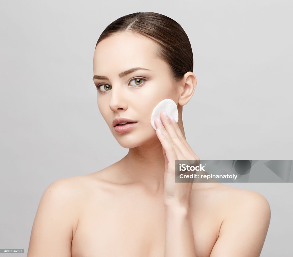 Beautiful Woman with Clean Fresh Skin Beautiful Face of Young Woman with Clean Fresh Skin close up isolated on white. Beauty Portrait. Beautiful Spa Woman Smiling. Perfect Fresh Skin. Pure Beauty Model. Youth and Skin Care Concept 2015 Stock Photo