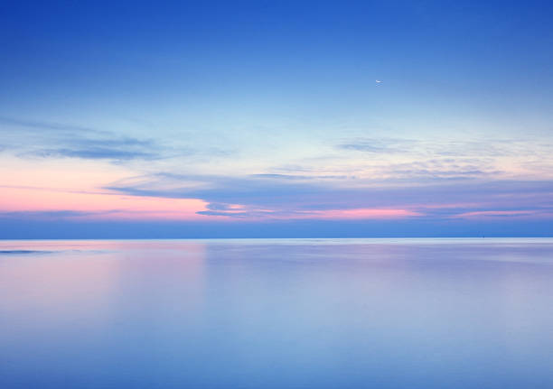 istock Beach sunrise with dramatic sky, sea and moon background 480154399