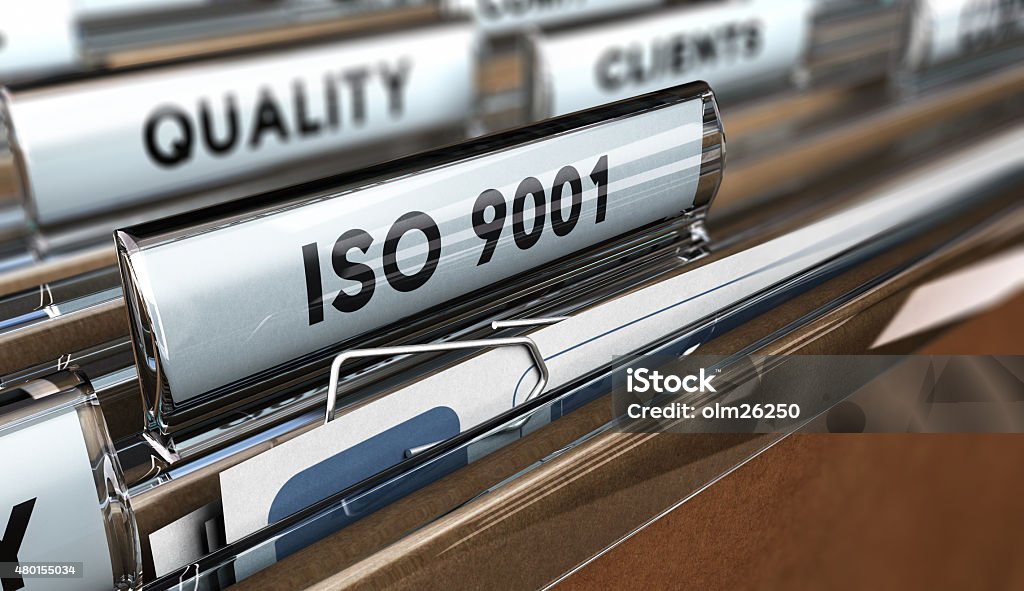 Quality Standards ISO 9001 Close up on a file tab with the word ISO 9001, focus on the main text and blur effect. Concept image for illustration of Quality Standards 2015 Stock Photo