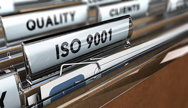 Quality Standards ISO 9001 Close up on a file tab with the word ISO 9001, focus on the main text and blur effect. Concept image for illustration of Quality Standards 2015 stock pictures, royalty-free photos & images
