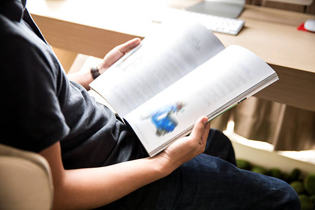 istock Man reading magazine in the office 480156140