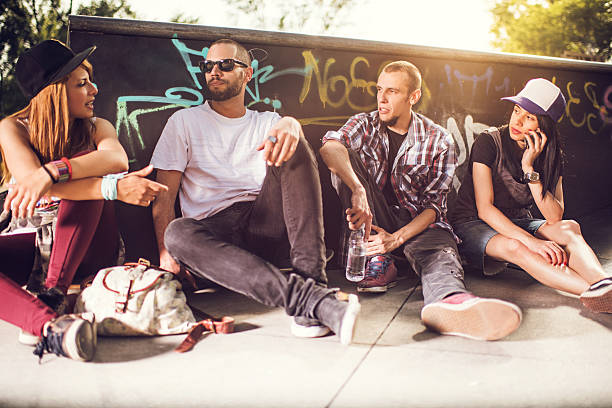 istock Young cool friends relaxing at the skate park and communicating. 480156666