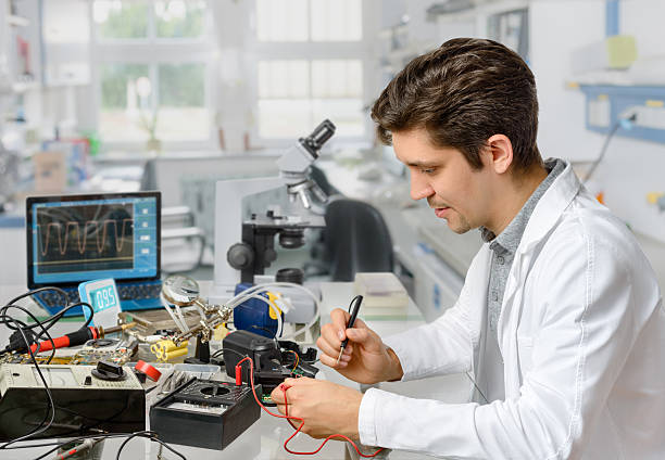 istock Young male tech or engineer repairs electronic equipment in rese 480156710