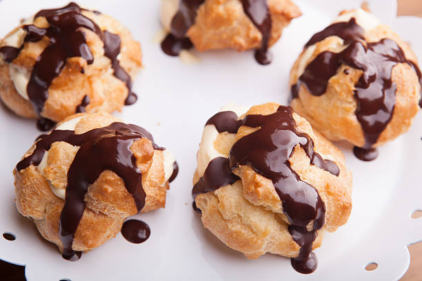 istock Cream puffs in dark chocolate 480157140