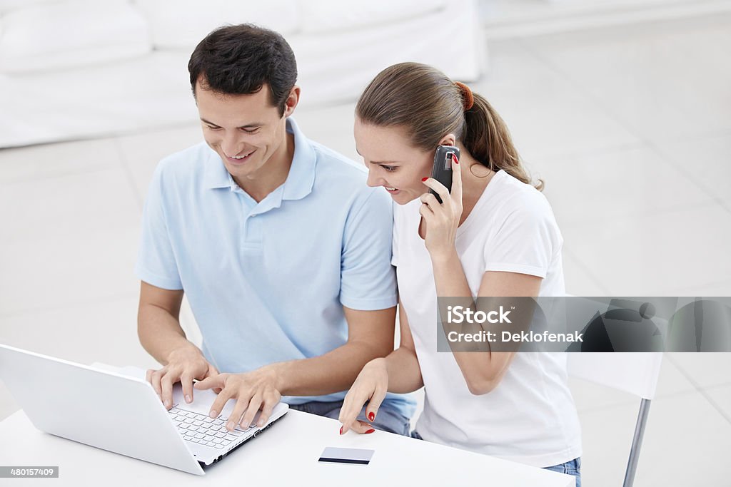 Finance Young couple with laptop and phone Adult Stock Photo
