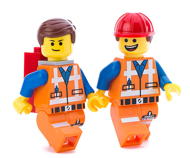 Ankara, Turkey - March 15, 2014 : A Lego minifigure is a small plastic articulated figurine available as part of the construction toy Lego. The Lego Movie is a 2014 American Australian computer animated comedy film directed based on the Lego line of construction toys and was released on February 7, 2014.  Two Lego movie minifigure characters Emmet isolated on white background.