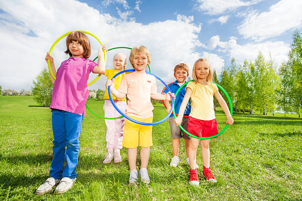 istock Group of children holding hula hoops in park 480166296