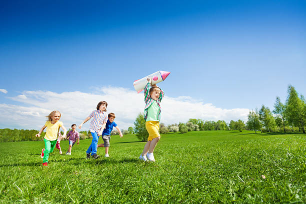 istock Children run after boy holding rocket carton toy 480166462