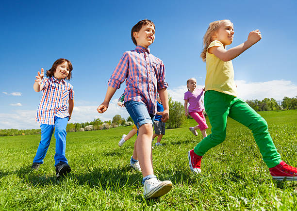 istock View from below of children running in the park 480166574