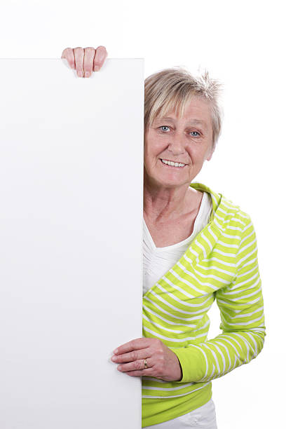 istock Happy older woman behind a white board 480170220