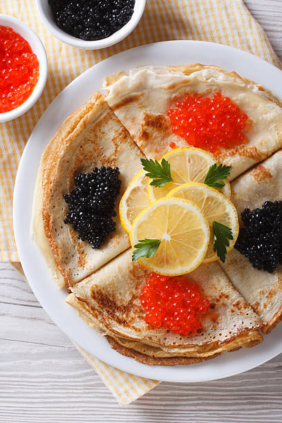 istock Pancakes with red and black caviar closeup, vertical top view 480170274