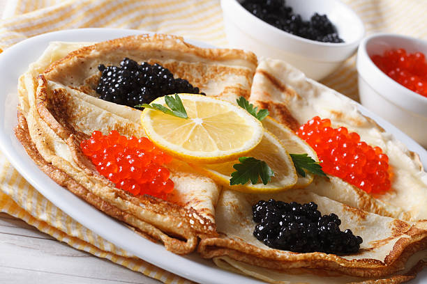 istock Thin pancakes with red and black caviar close-up, horizontal 480170536