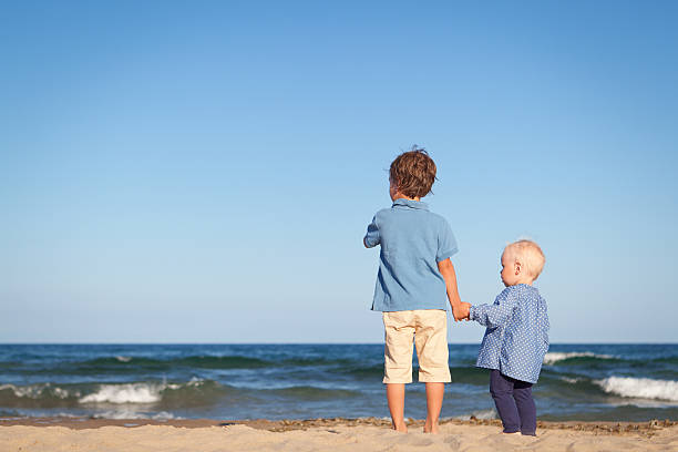 Brother and sister on walk near sea, outdoor