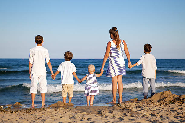 istock Children are standing on beach 480172135
