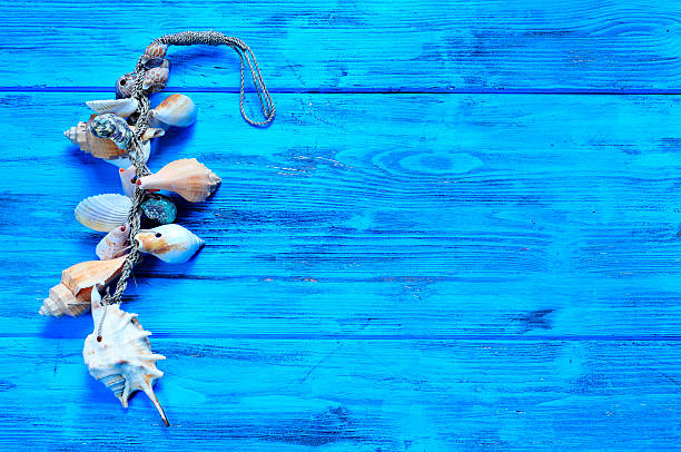 istock ornament made from seashells on a blue wooden surface 480175568